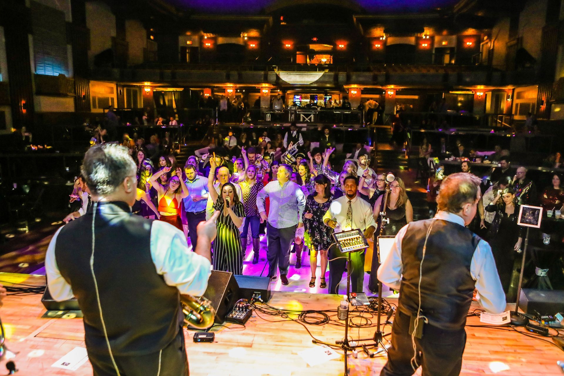 Mainstreet Soul is playing instruments on a stage in front of a crowd.