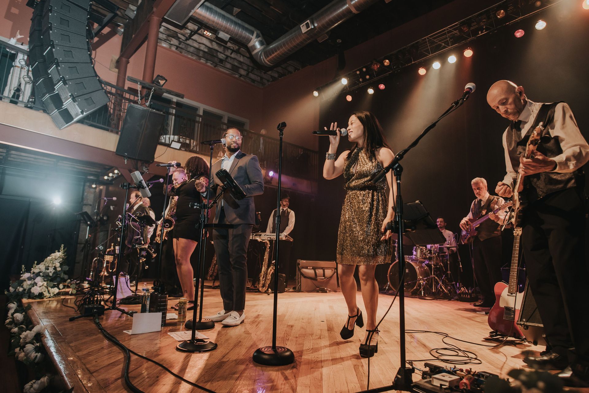 Mainstreet Soul is standing on a stage singing into microphones in Detroit, Michigan.