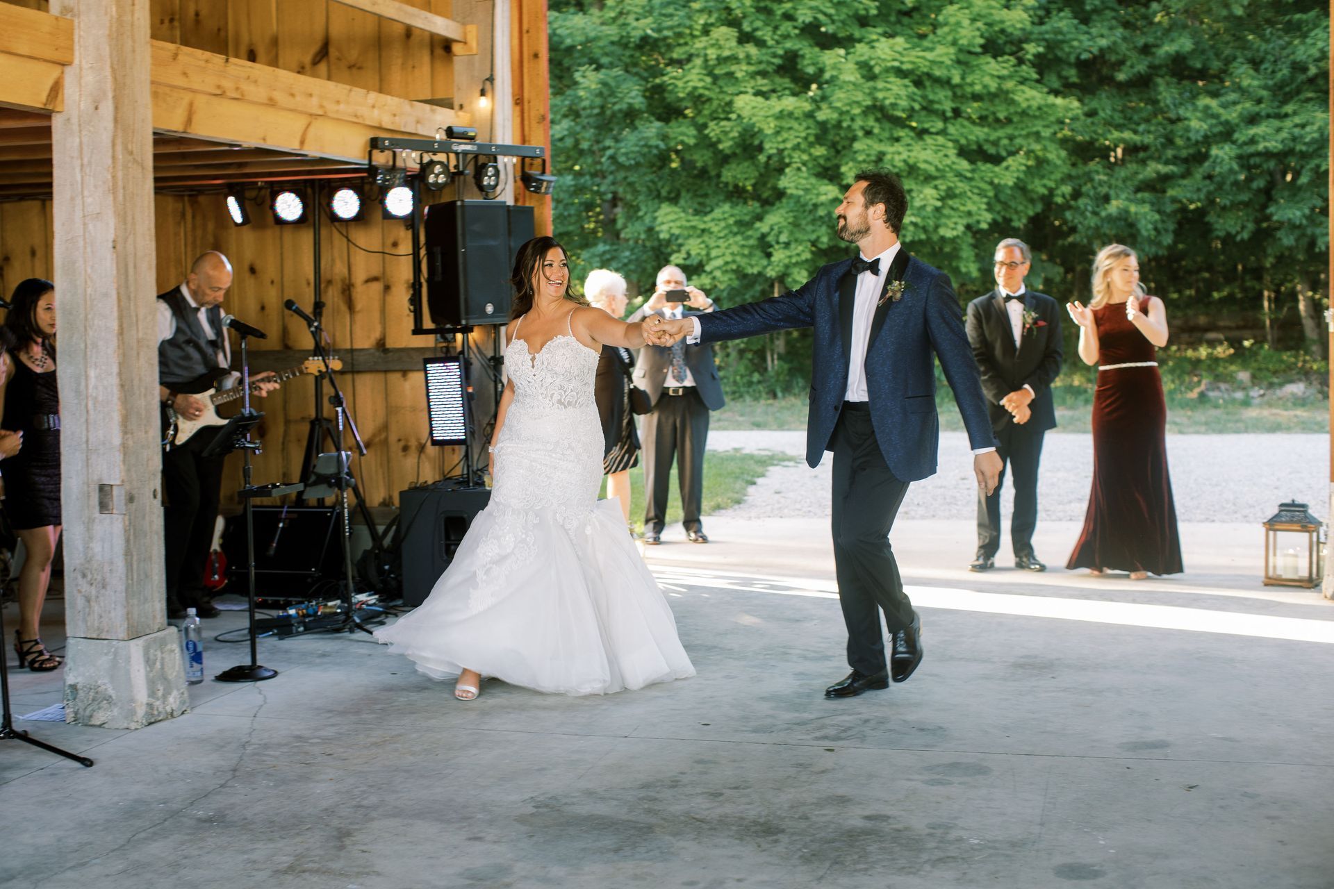 a bride and groom are dancing in front of Main Street Soul in Michigan