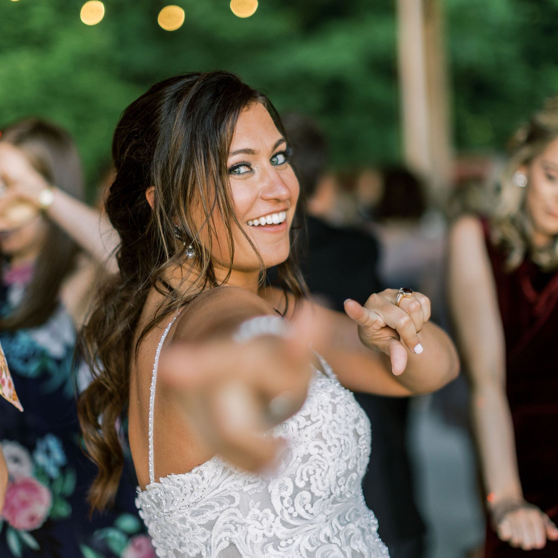 a woman in a wedding dress is dancing and smiling while Main Street Soul is performing in Detroit, Michigan