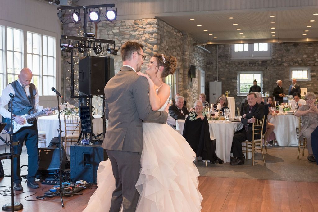 a bride and groom are dancing to a song by Main Street Soul at their wedding reception in Detroit, Michigan