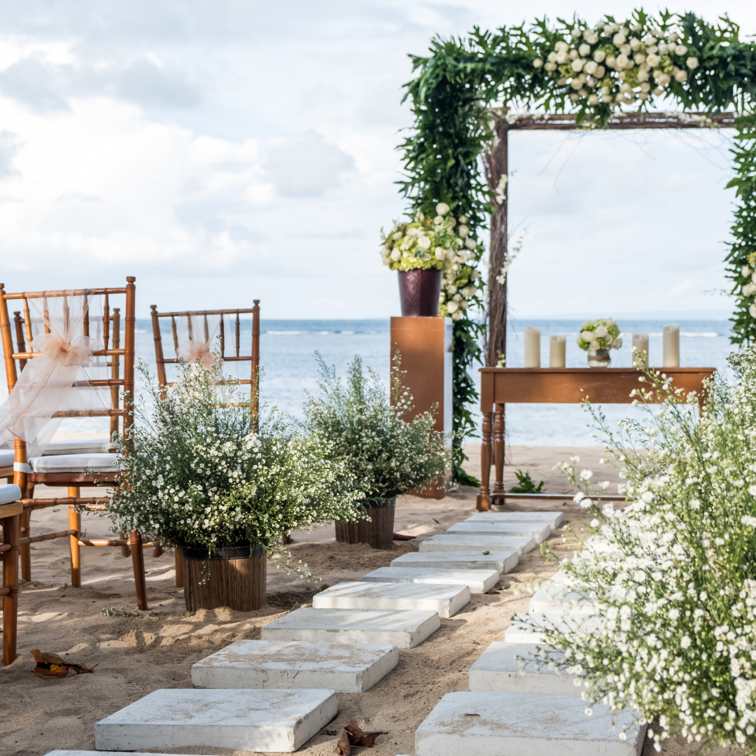 a wedding ceremony is taking place on the beach .