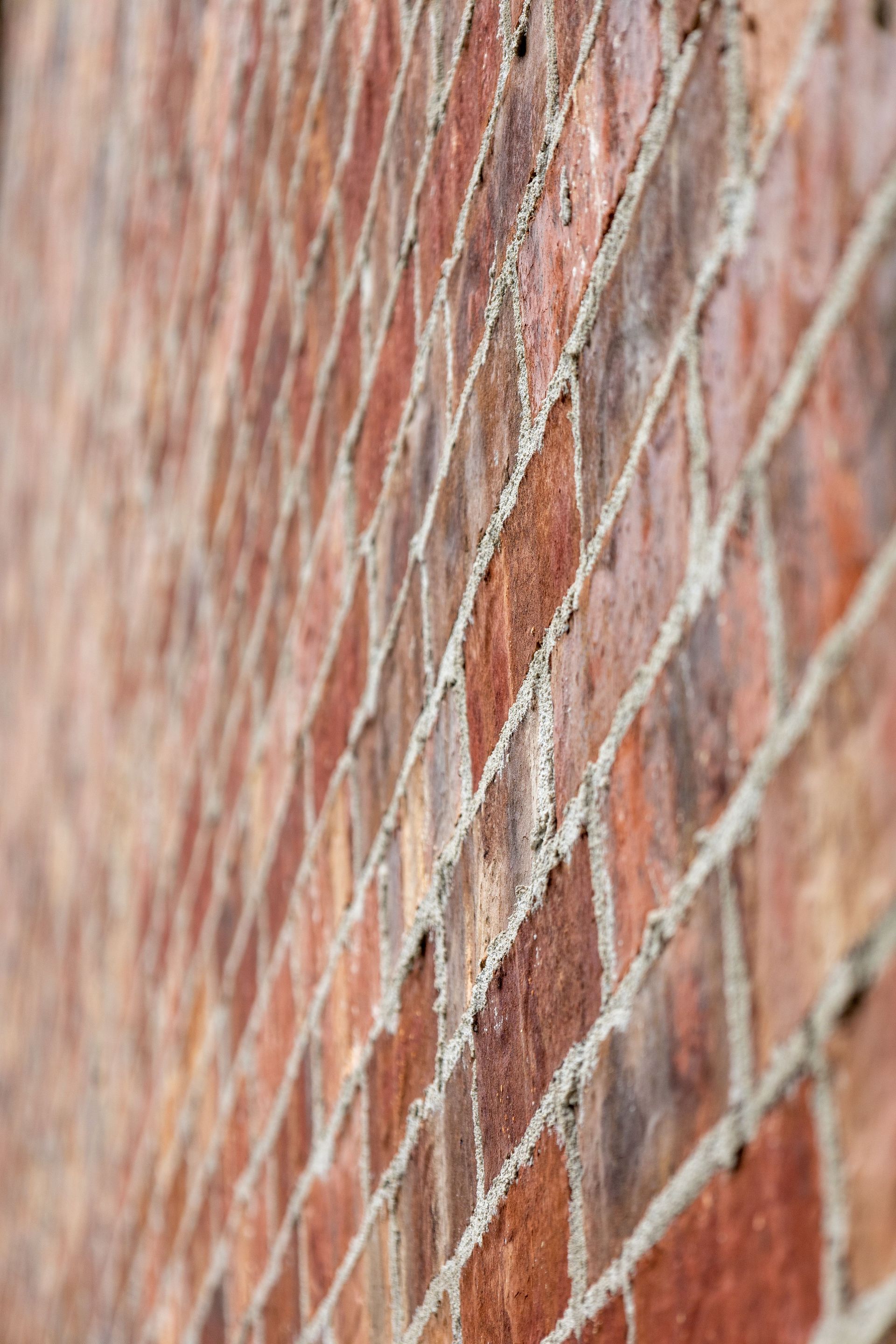 uckpointing mortar joints on a brick wall to prevent water damage