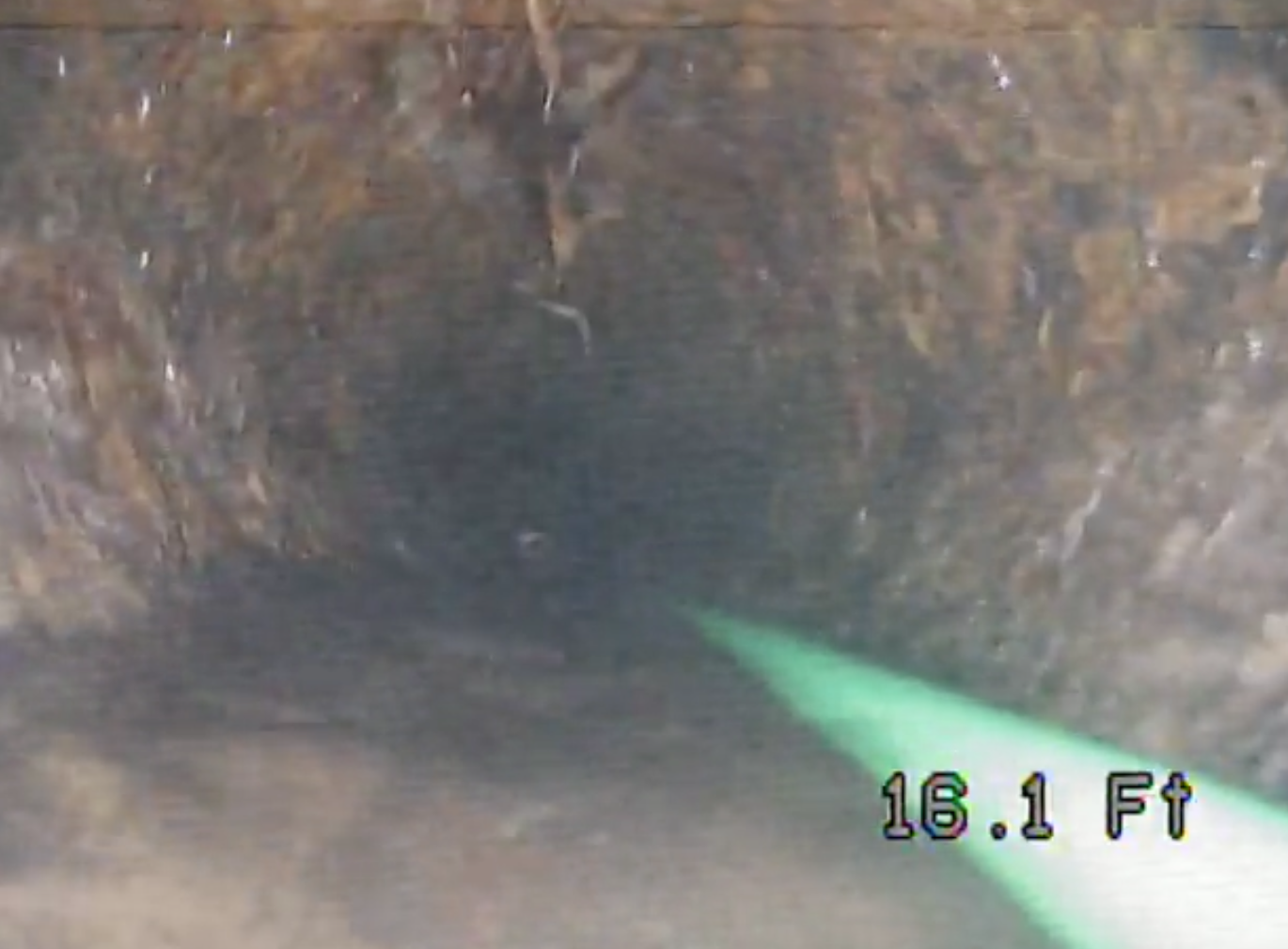 Dark tunnel interior with a green arrow overlay and “18.1 Ft” measurement text
