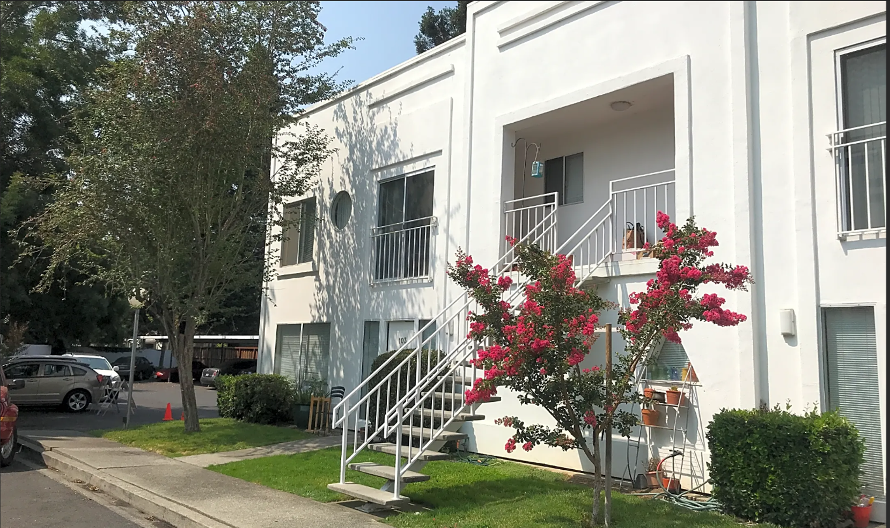 Photo showing an apartment building with steps leading to the upstairs units
