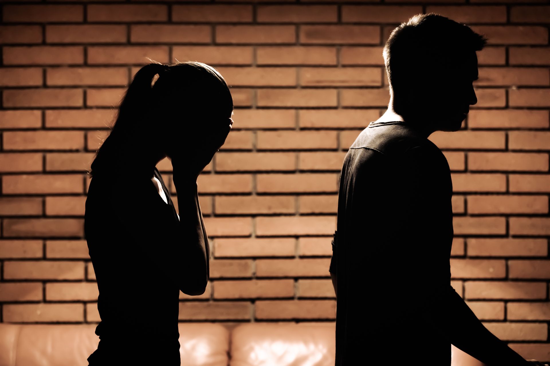 Therapist comforting a person in a support group. Hand on shoulder, holding clipboard.