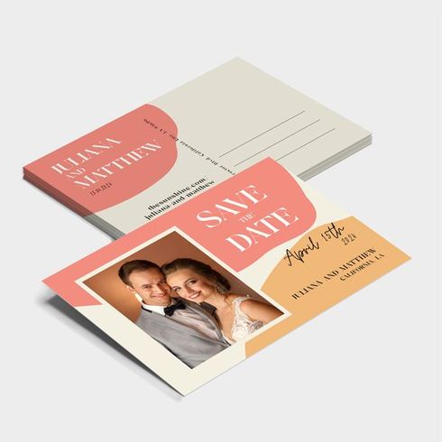 Wedding invitation suite with coral and cream cards and a couple’s photo on the save-the-date card