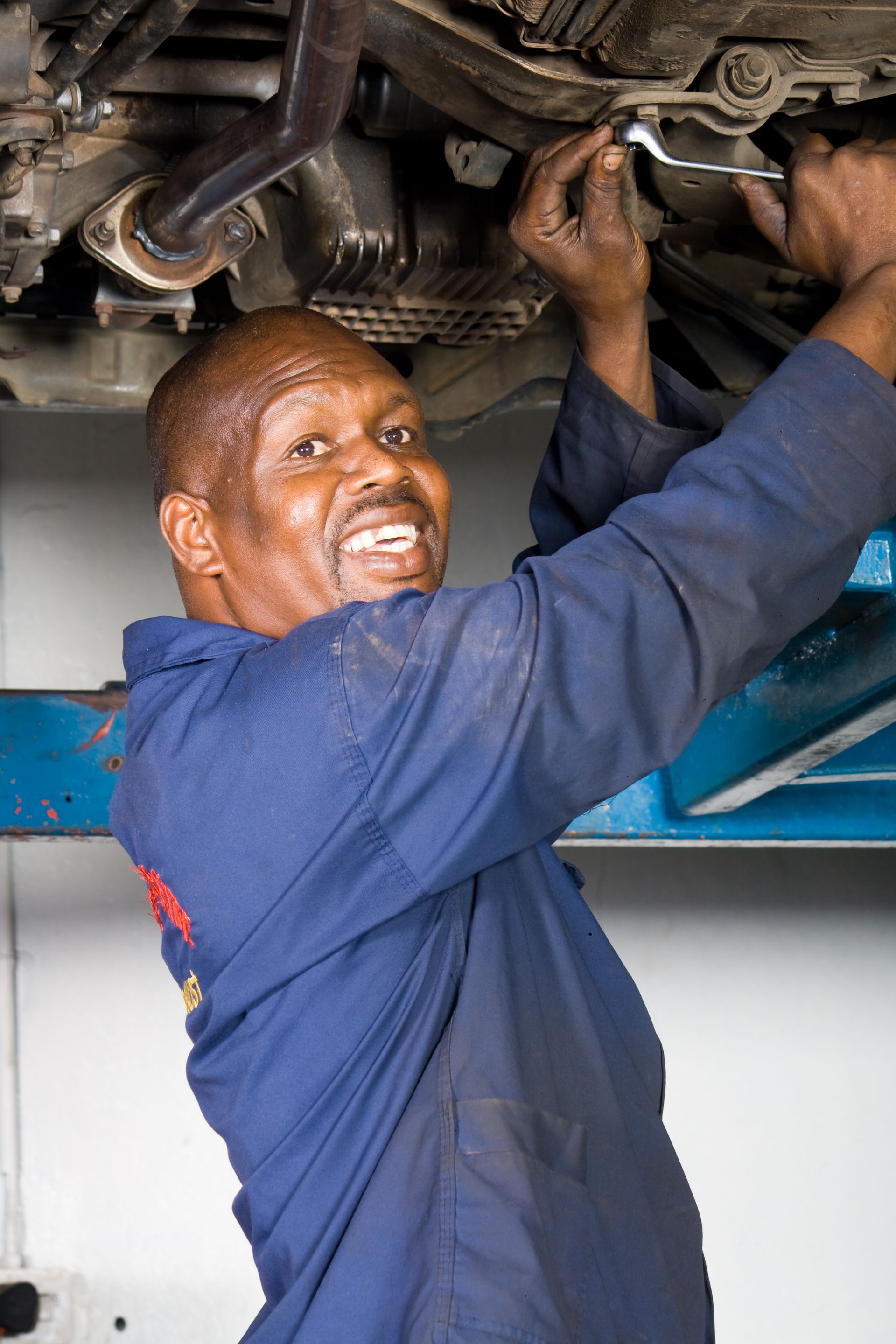 A man working on a car, showcasing automotive body repair skills in Athens, GA. 