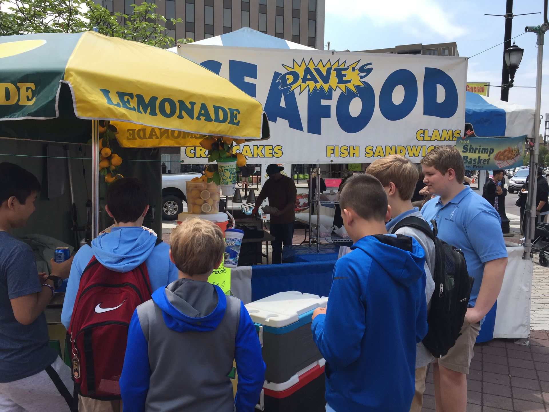People buying food from a food stand;