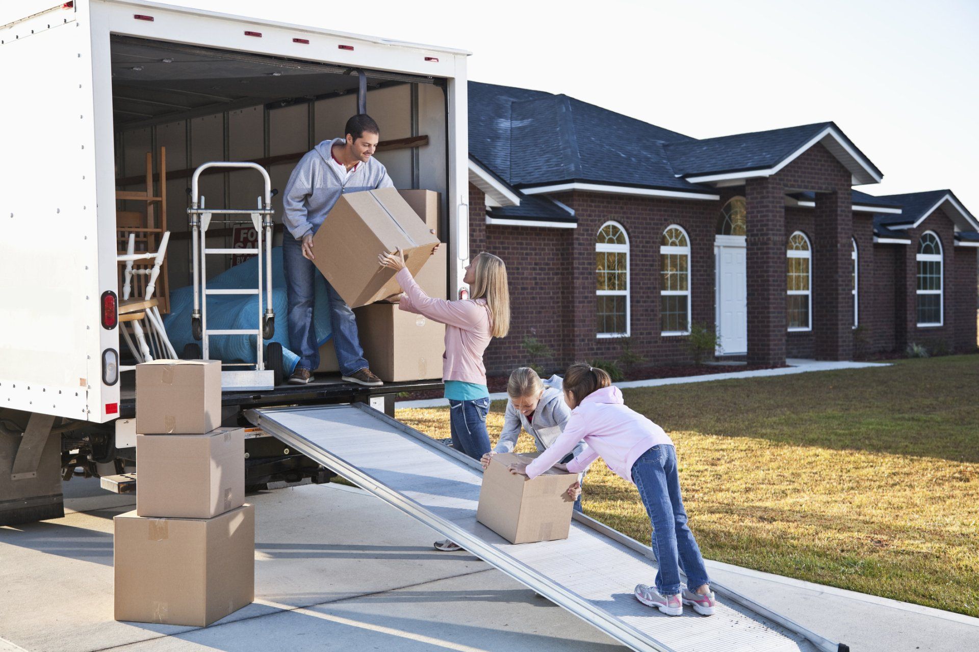 Family Carrying Boxes To Truck — Dayton, NV — Ace Mini Storage Family Carrying Boxes To Truck — Dayton, NV — Ace Mini Storage