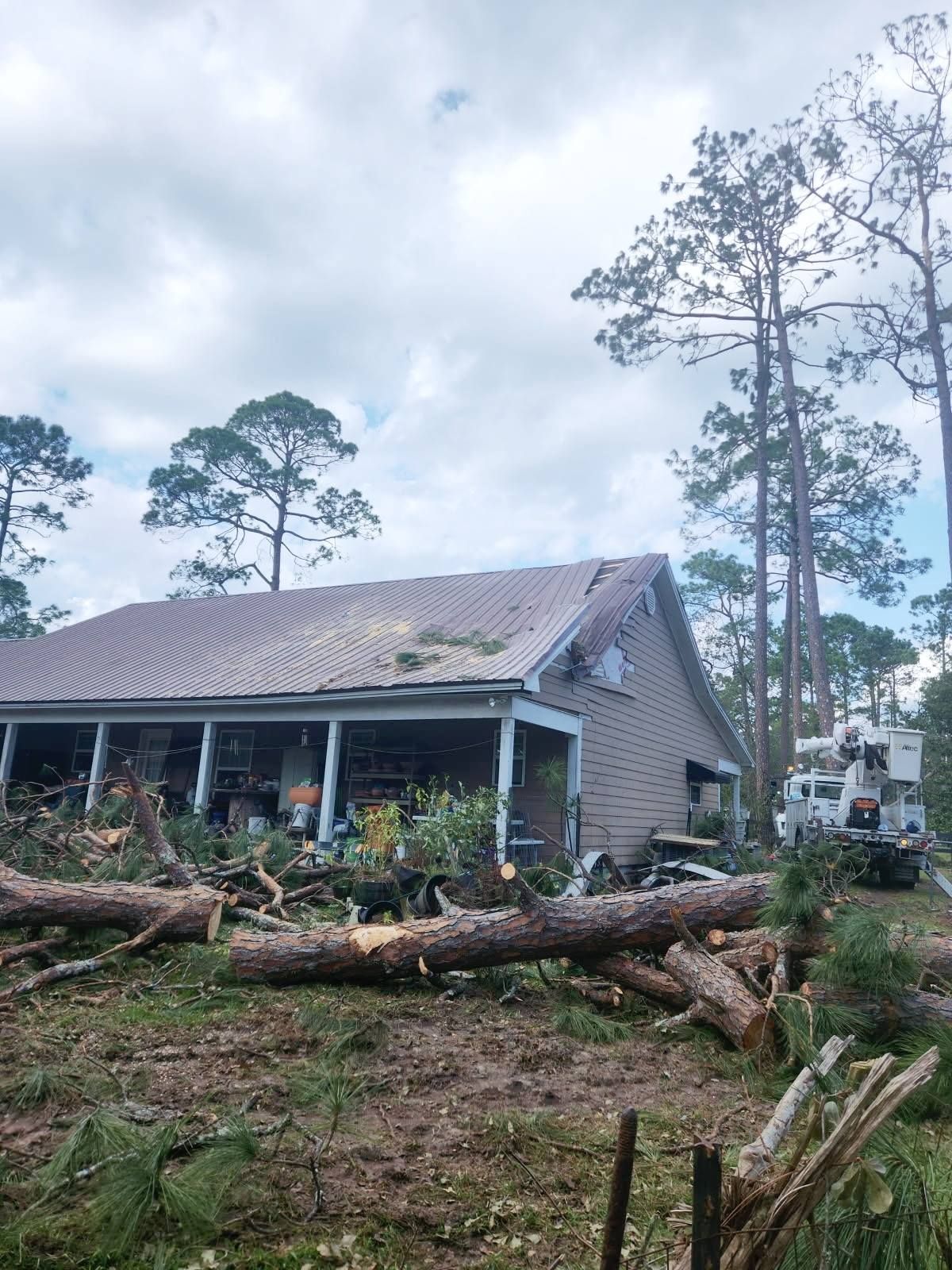 A house with a roof that has been damaged by a tornado.