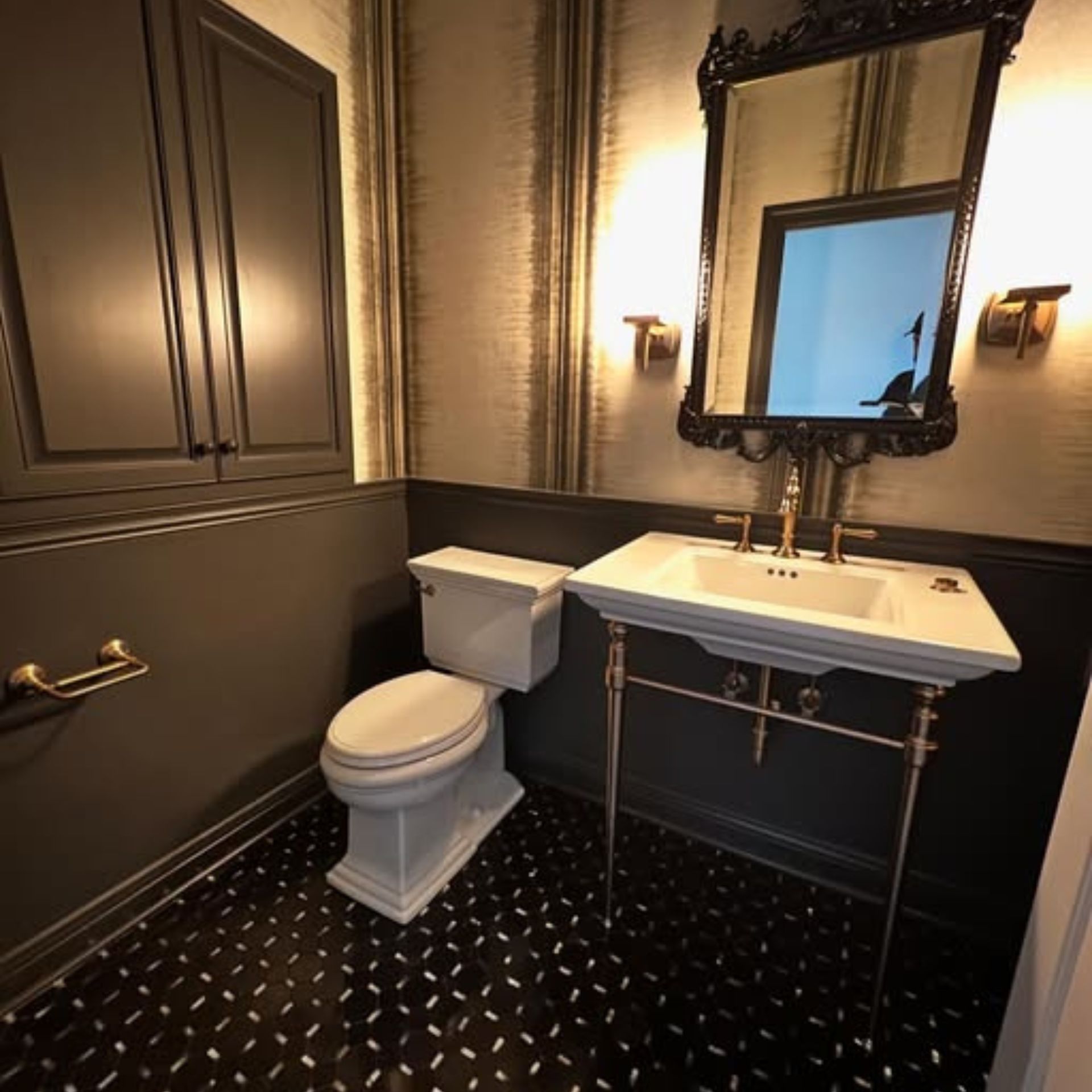 WCL Construction/Paint & Carpentry Inc - A bathroom with a toilet a sink and a mirror
