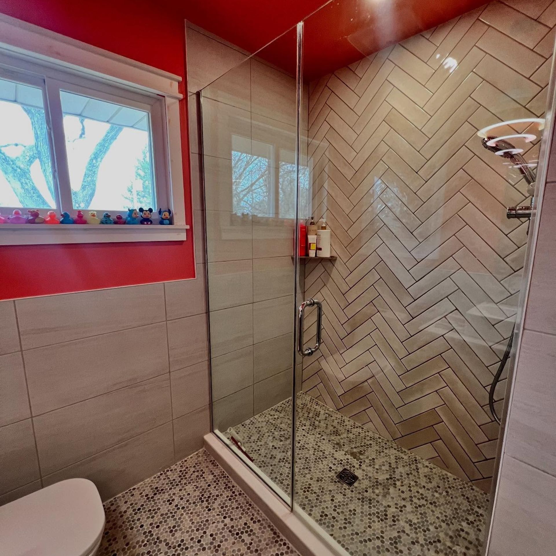 WCL Construction/Paint & Carpentry Inc - A bathroom with a walk in shower and a toilet
