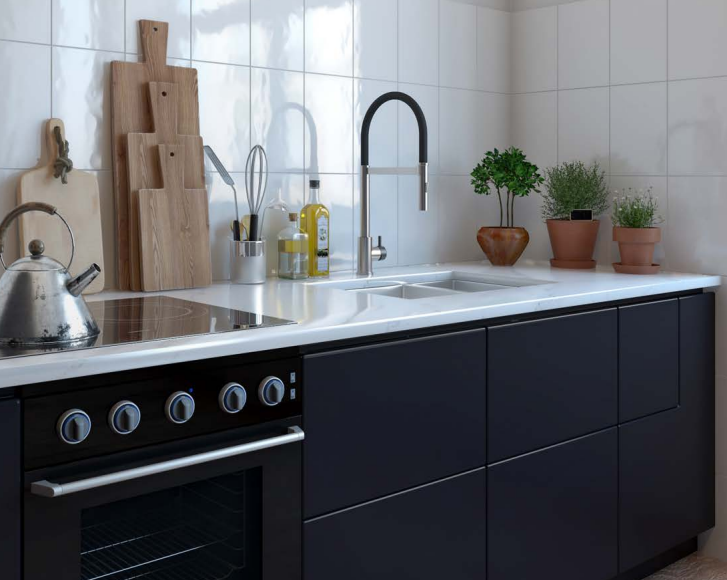 Modern kitchen with black cabinets, white backsplash, sink, stove, and potted herbs on the counter