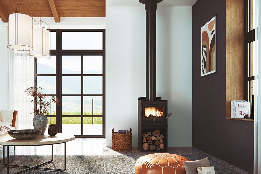 Display of black wood stoves in a showroom with signs and brochures above them