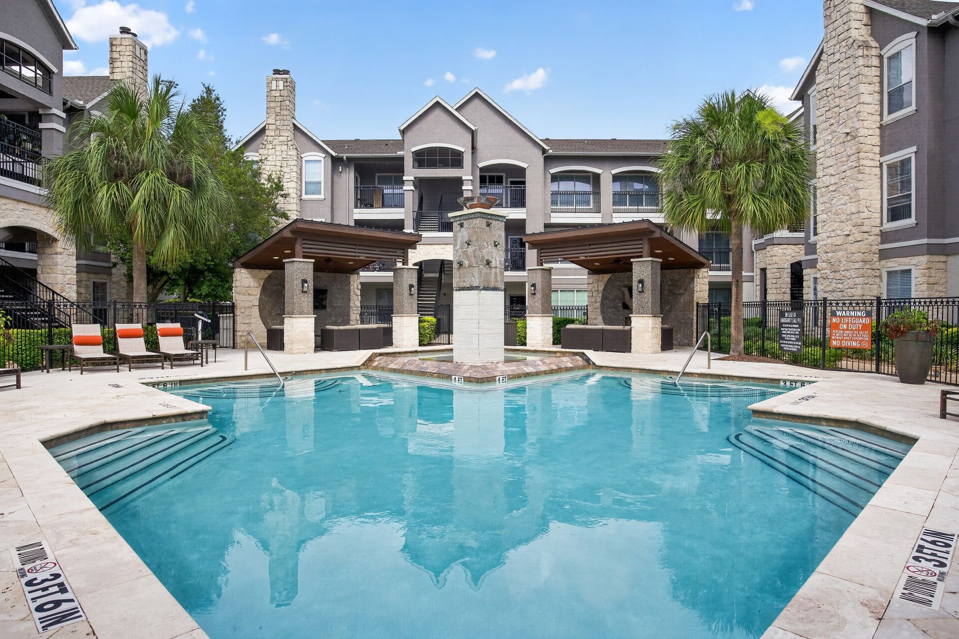 Aerial view of an apartment complex with a central courtyard and swimming pool at Westpark Ranch Apartments in Houston, TX.