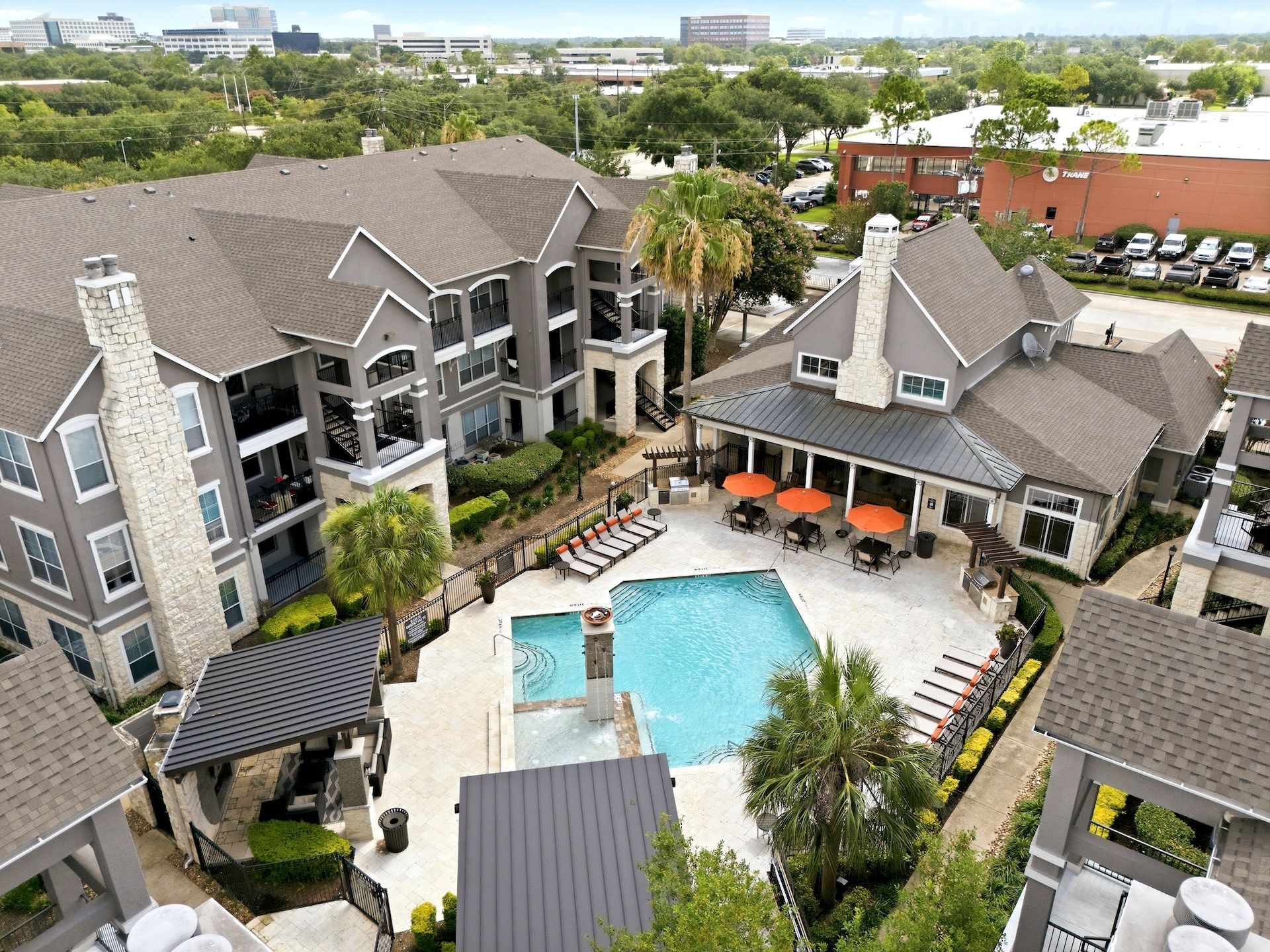 Real estate agent showing a bright kitchen to two clients, holding a folder and pointing toward the room at Westpark Ranch Apartments in Houston, TX.