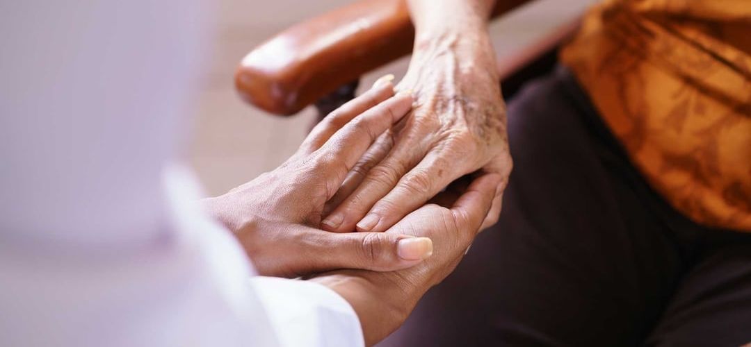 person holding the hand of an older person