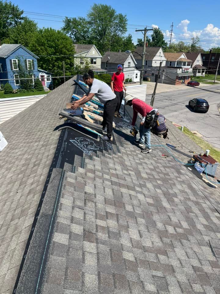 A group of men are working on a roof.