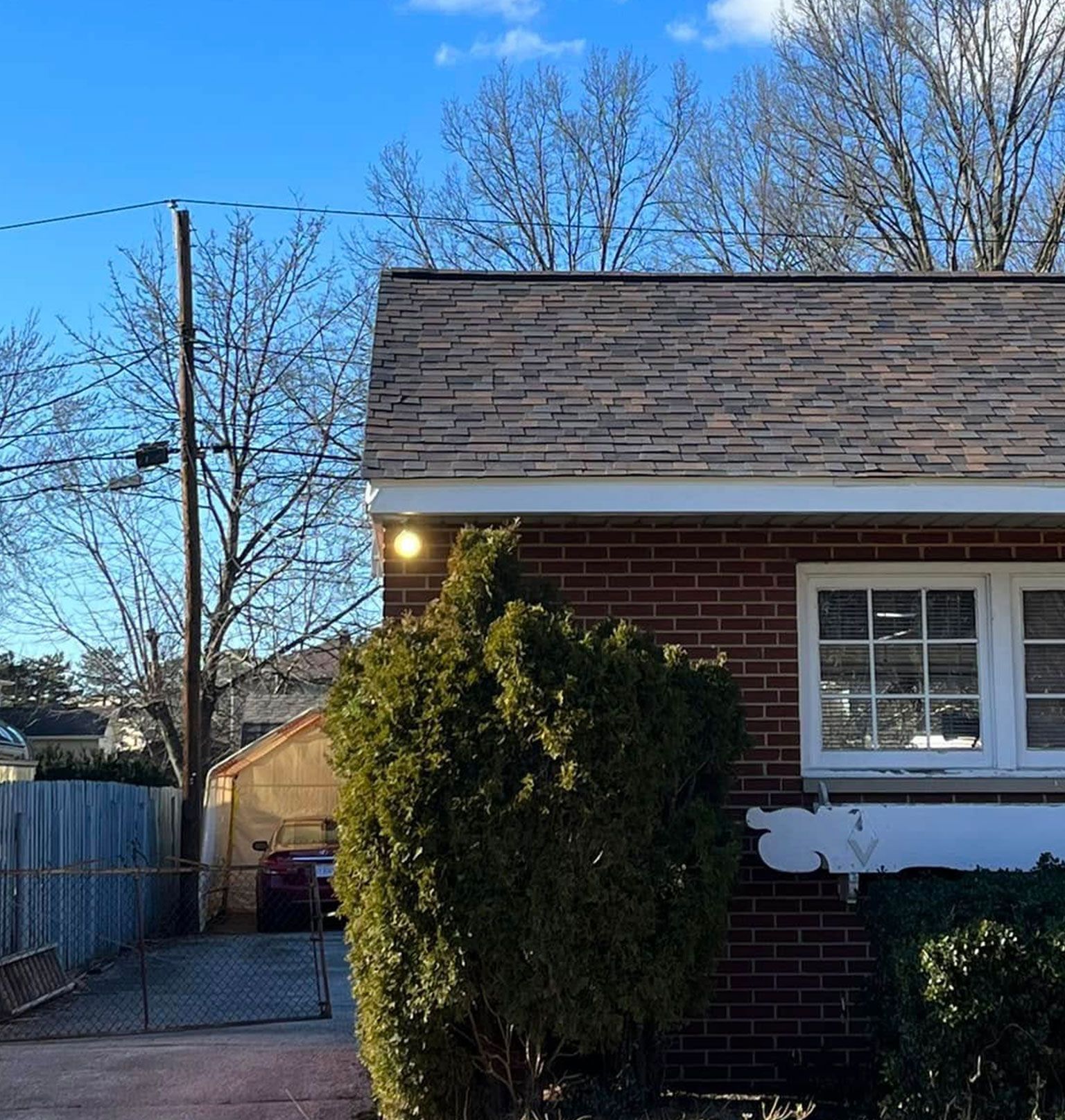 A brick house with a car parked in the driveway