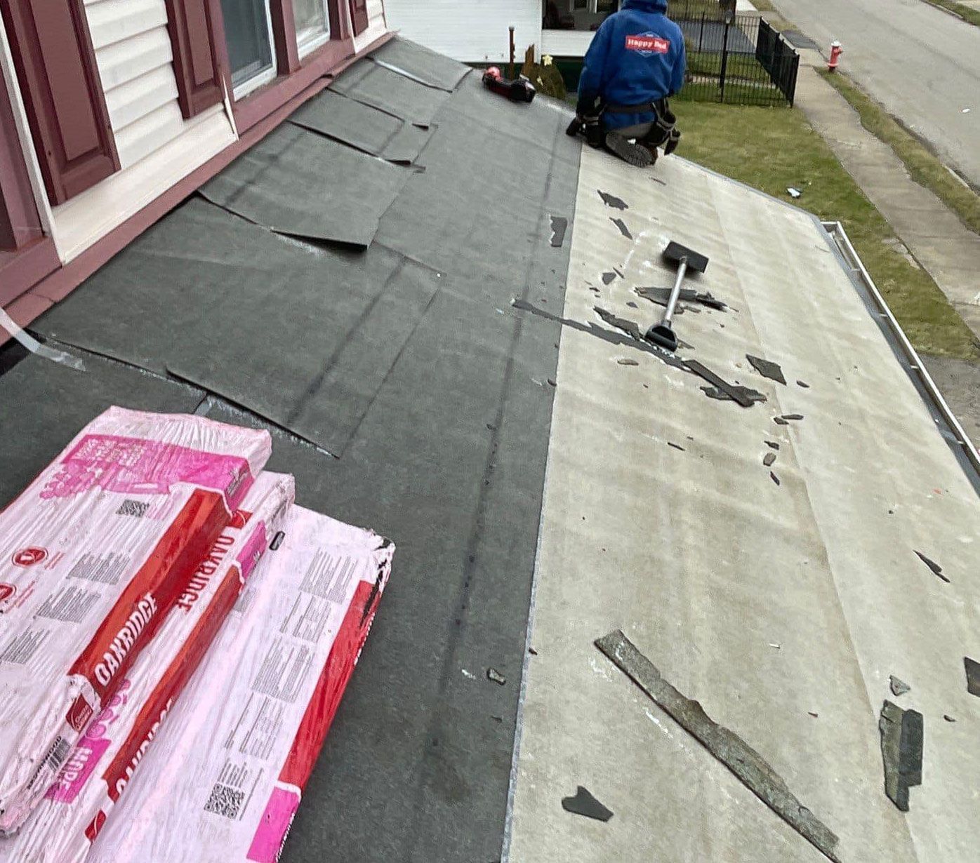 A man is working on the roof of a house.