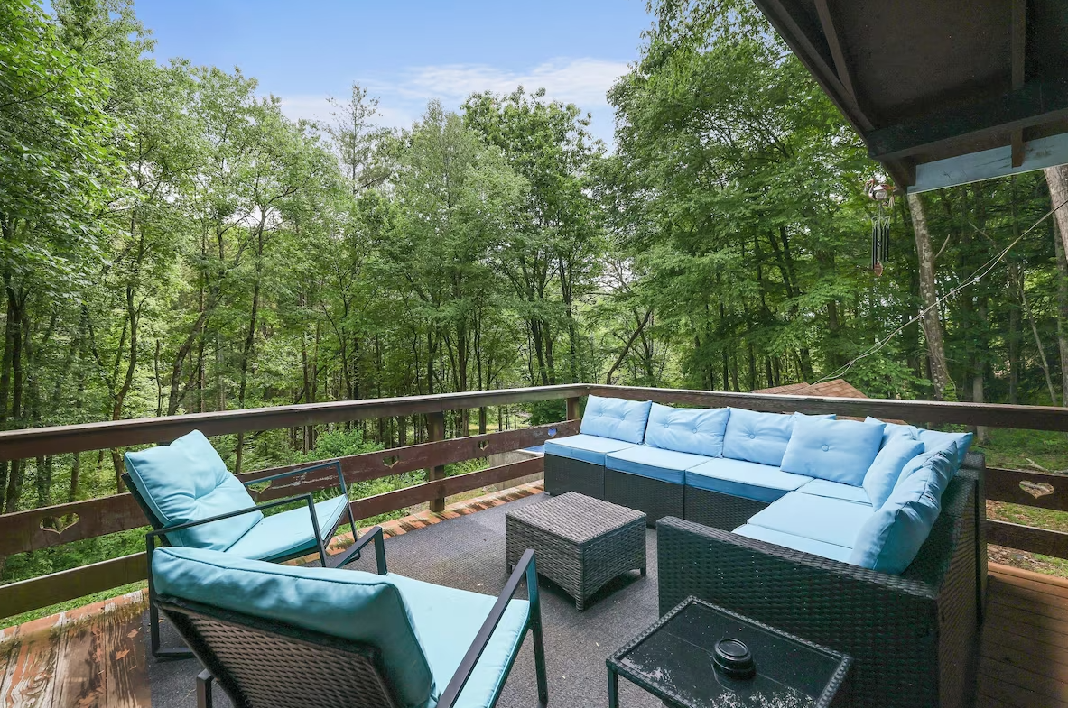 There is a patio with a couch and chairs on it.