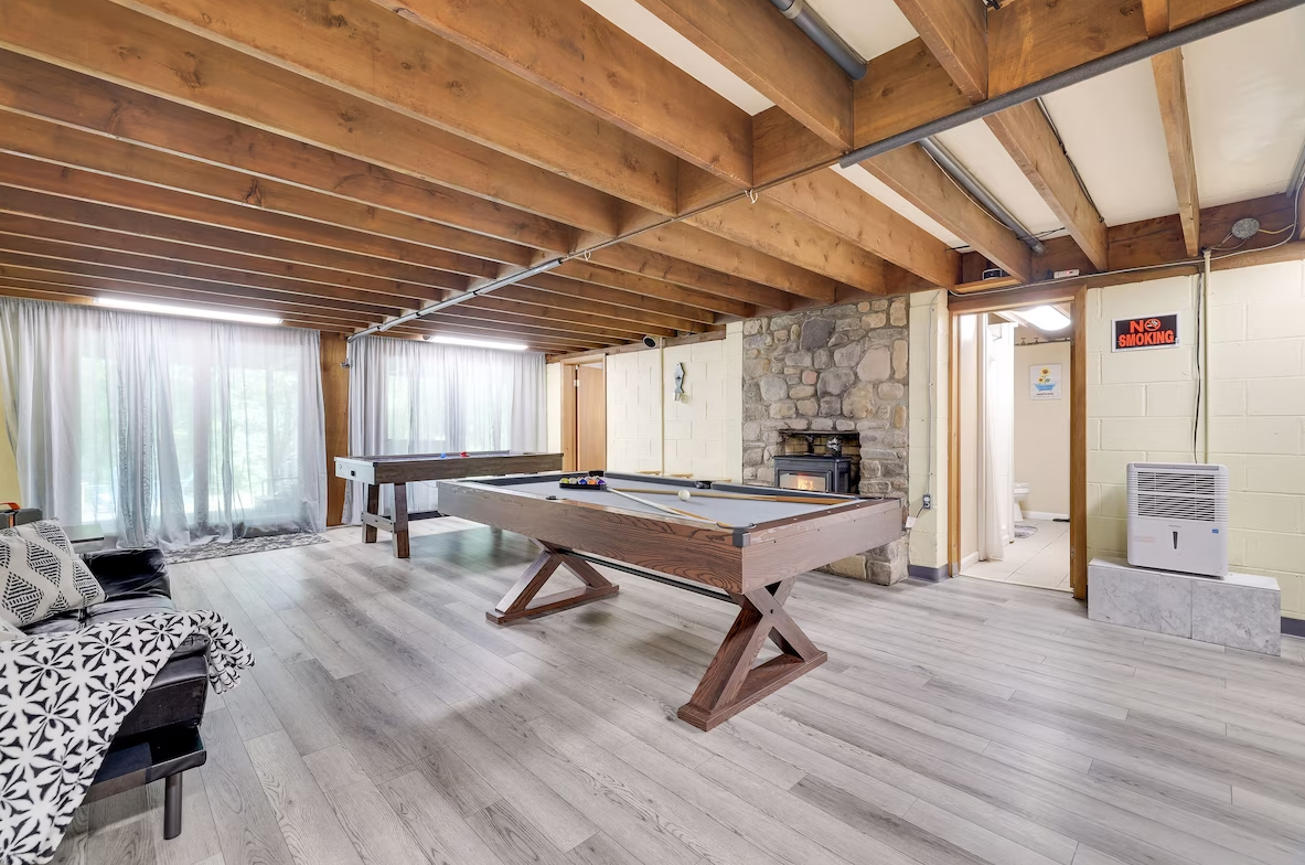 There is a pool table in the middle of the room.