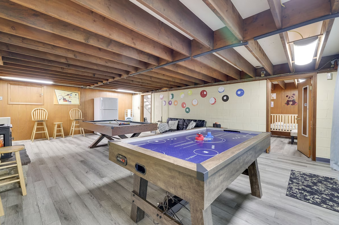 There is a pool table in the middle of the room.