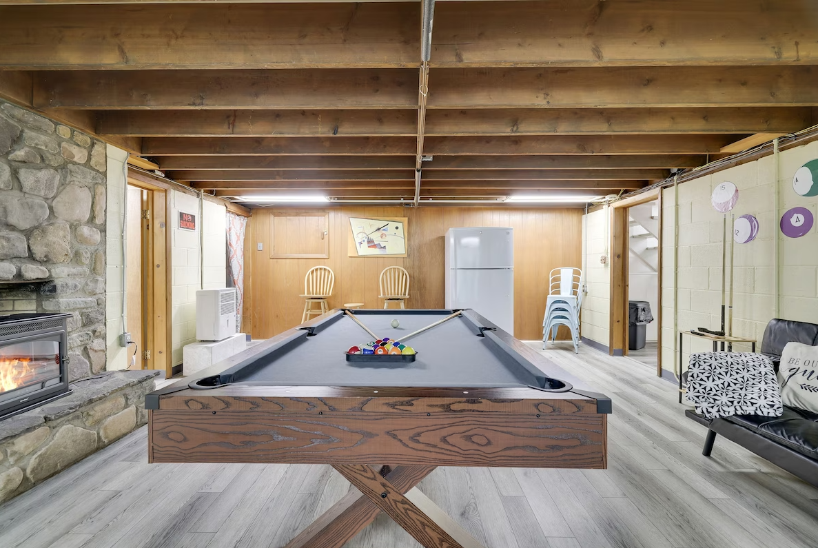 There is a pool table in the middle of the room.