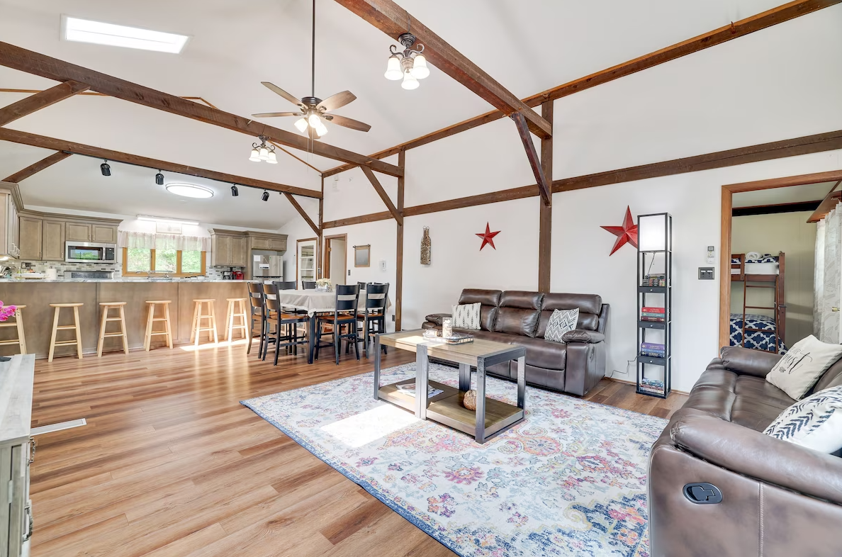 A living room filled with furniture and a ceiling fan.