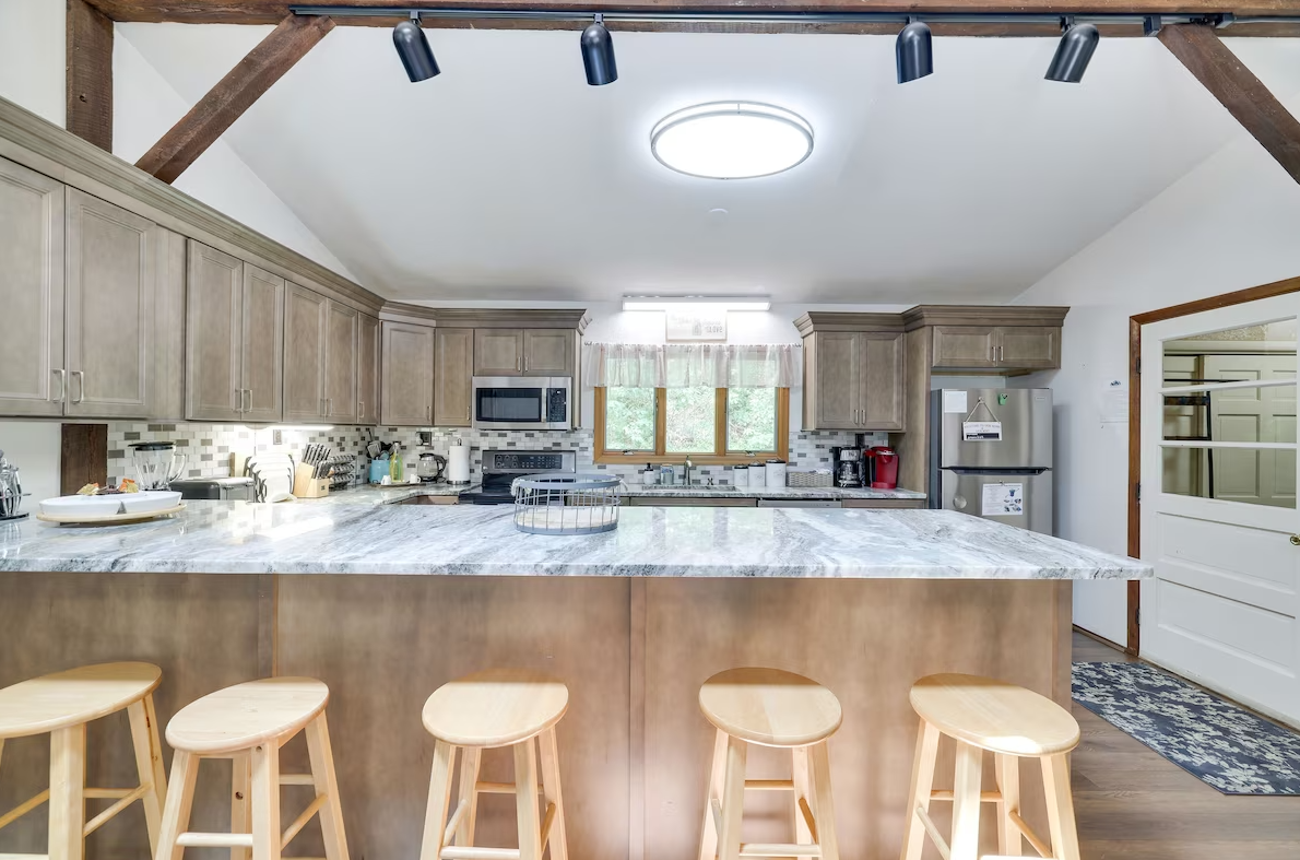 A kitchen with a large island and stools