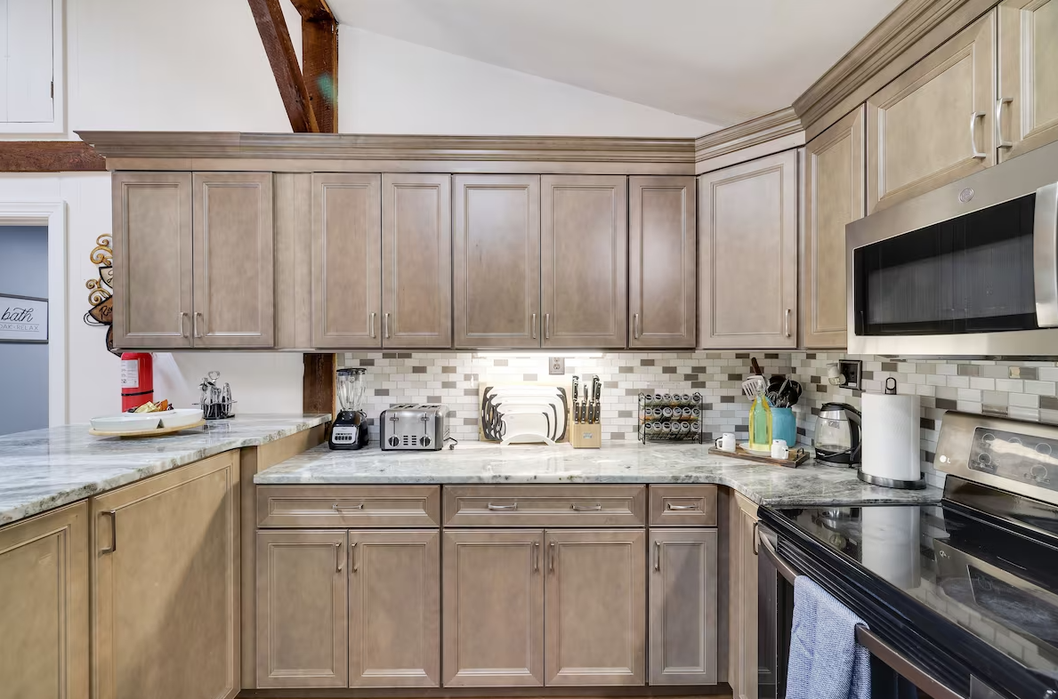 A kitchen with stainless steel appliances and wooden cabinets.