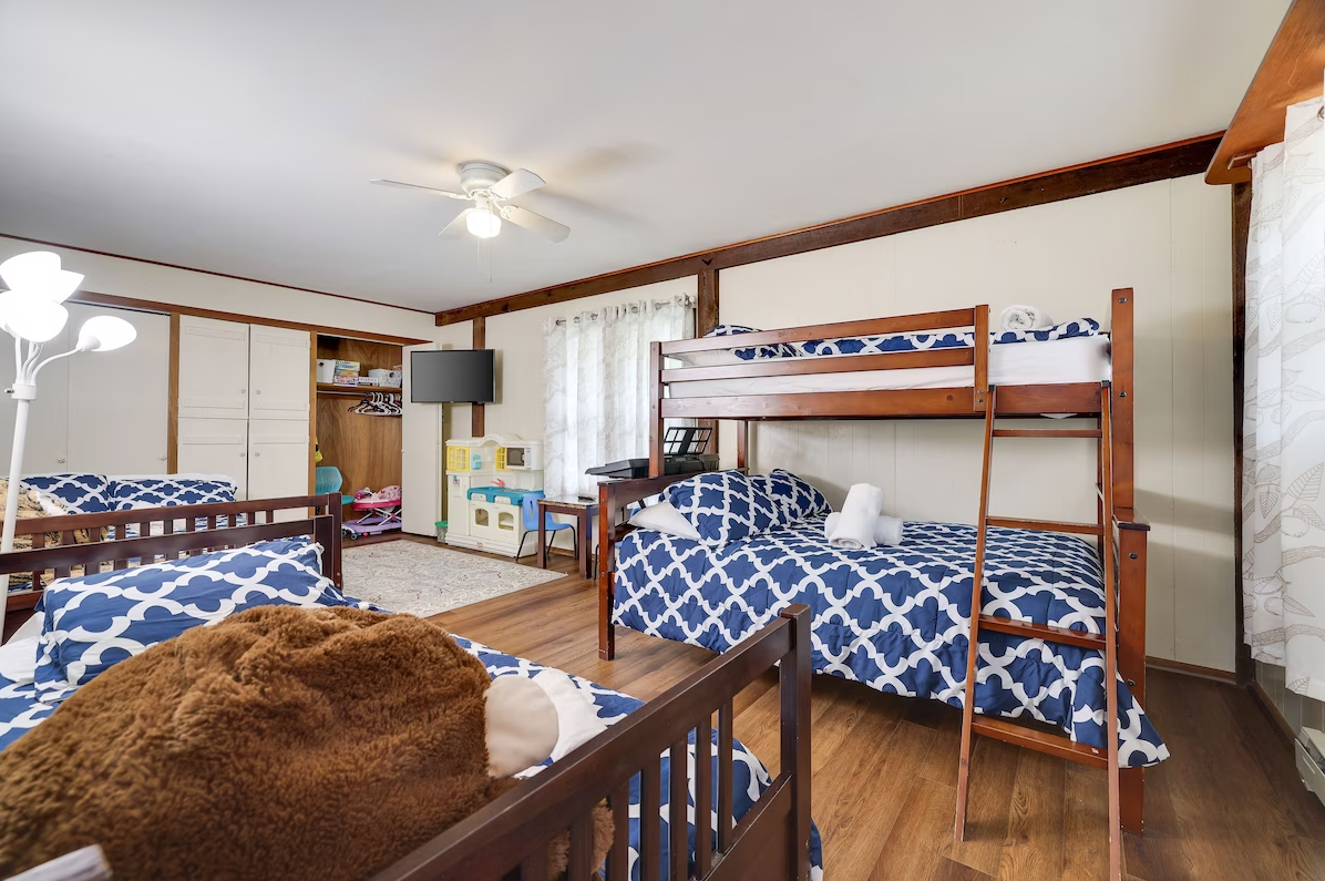 A bedroom with three bunk beds and a crib.