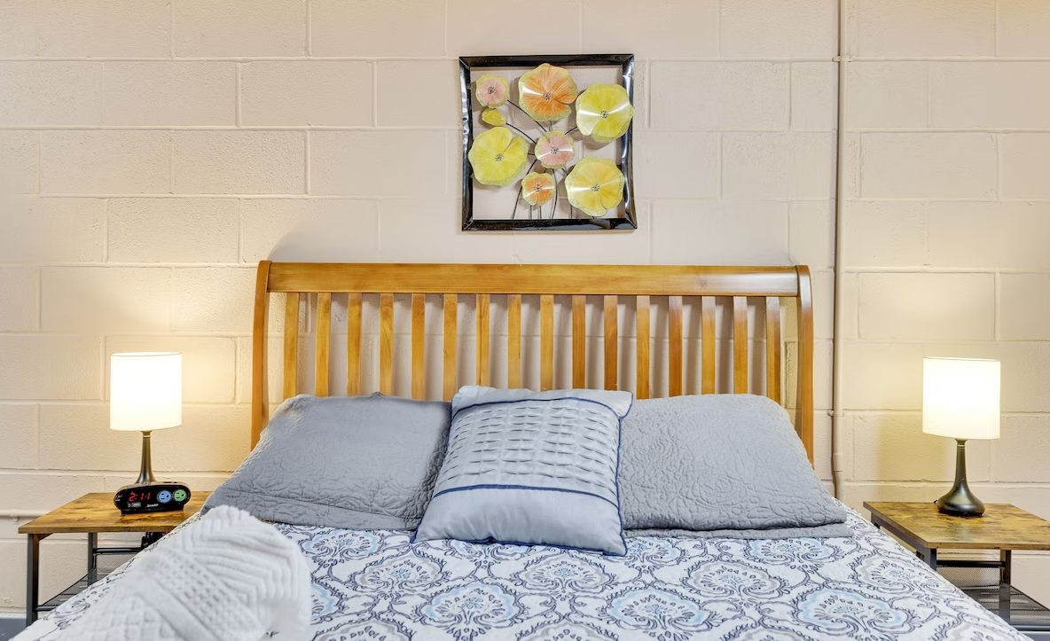 There is a picture of flowers on the wall above the bed.