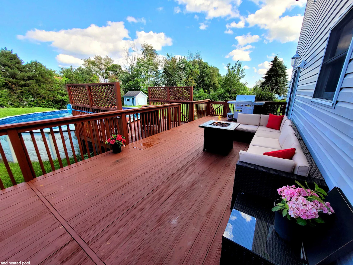 A wooden deck with a couch and a table on it