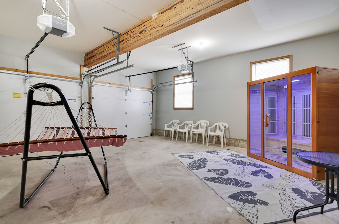 A garage with a sauna and chairs in it.