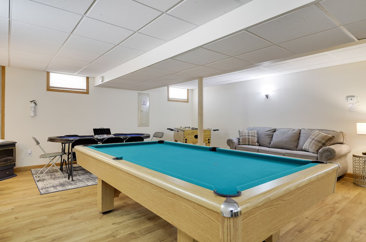 There is a pool table in the middle of the room.
