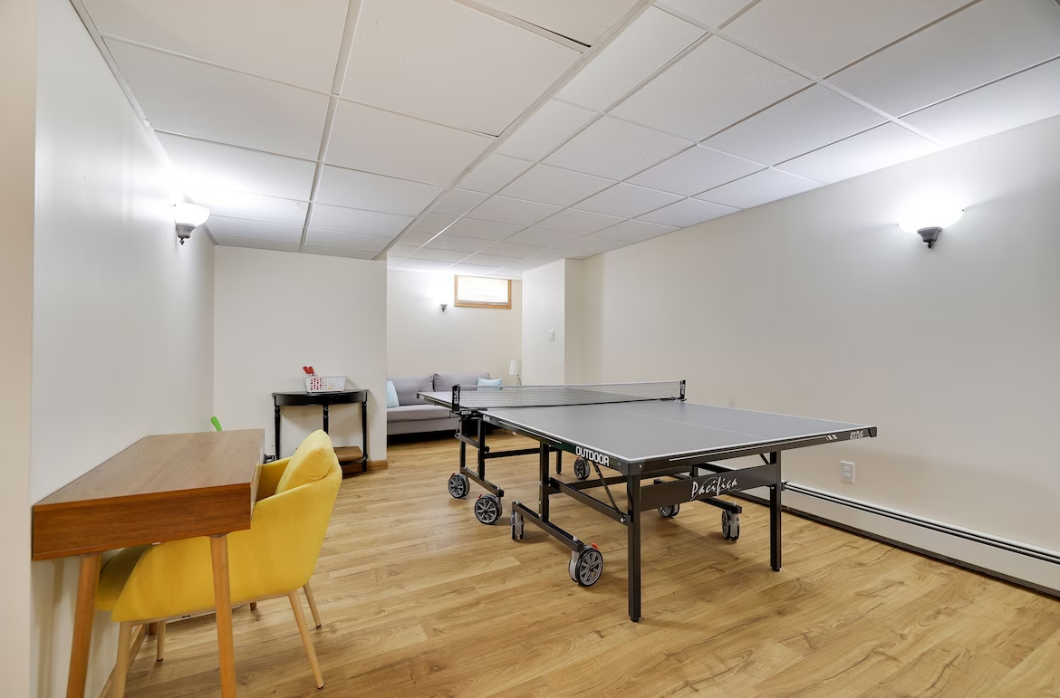 There is a ping pong table in the middle of the room.