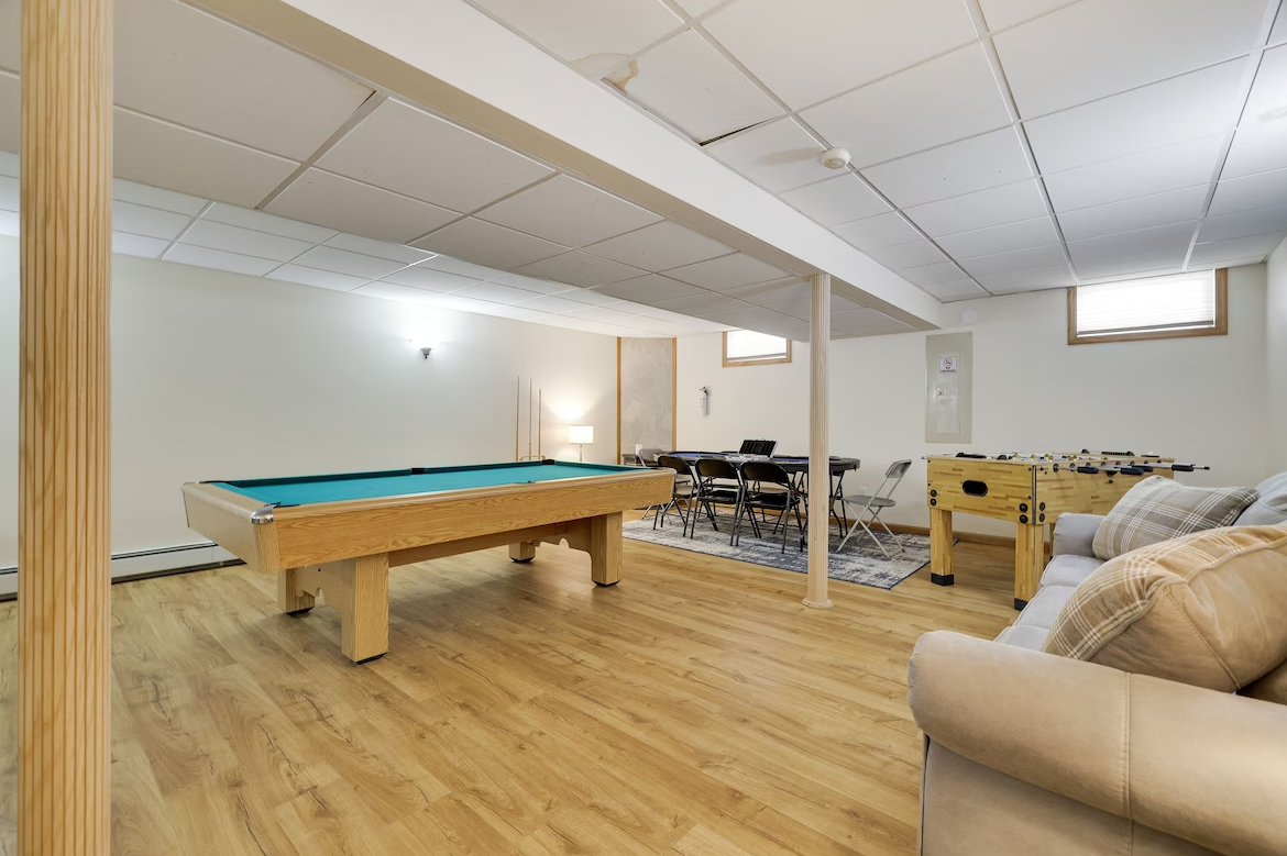 There is a pool table in the middle of the room.