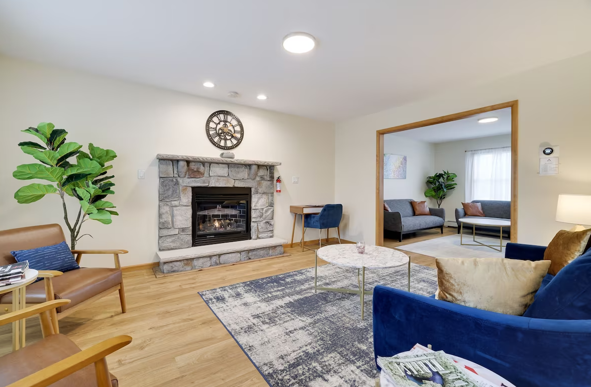 A living room filled with furniture and a fireplace.