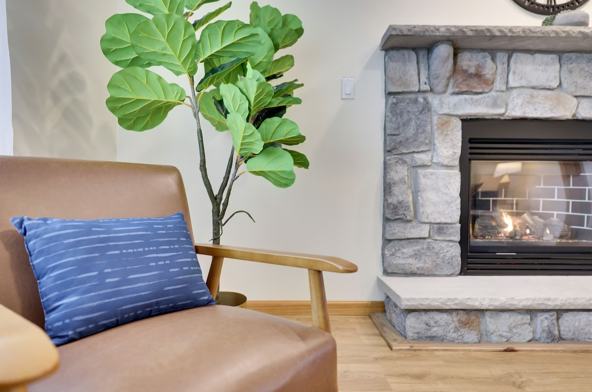 A living room with a fireplace and a chair.