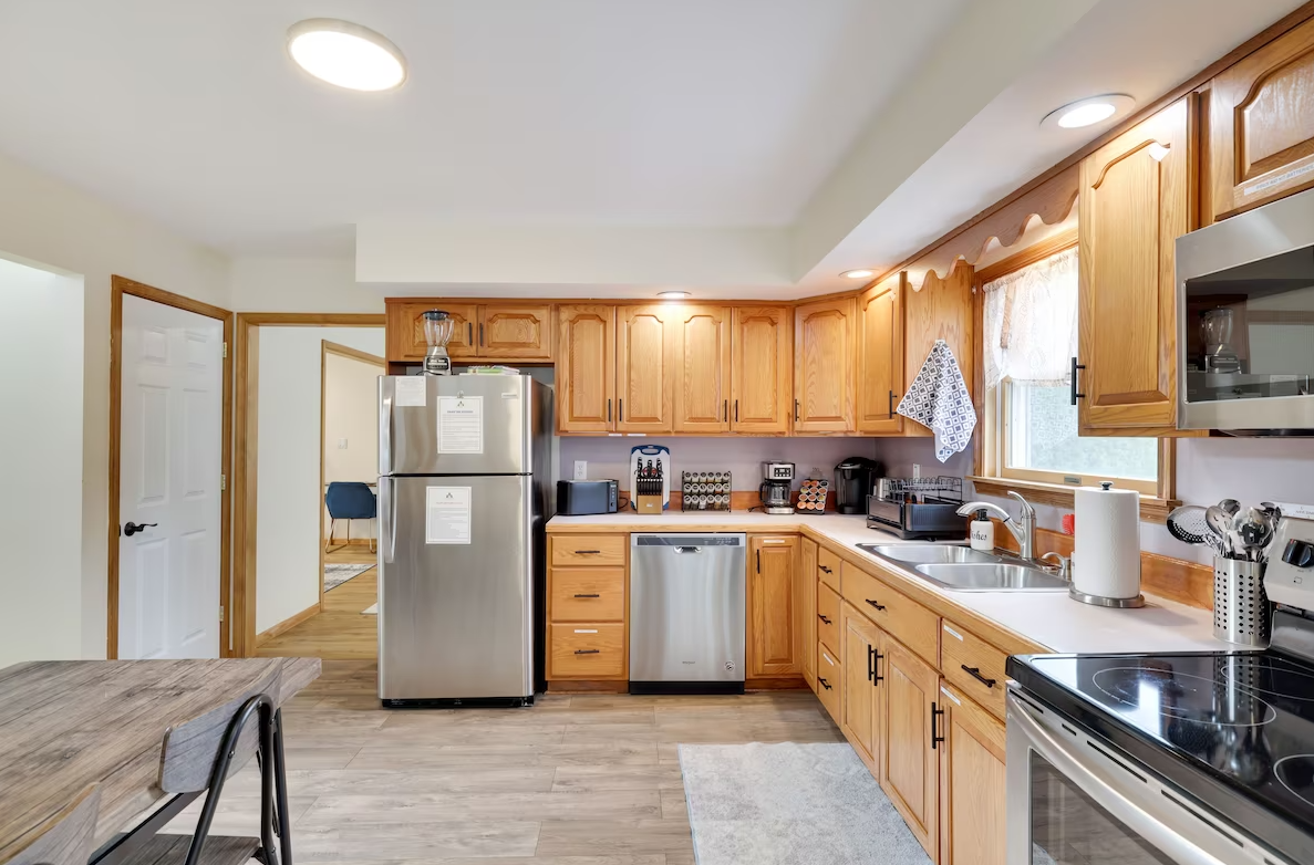 A kitchen with stainless steel appliances and wooden cabinets