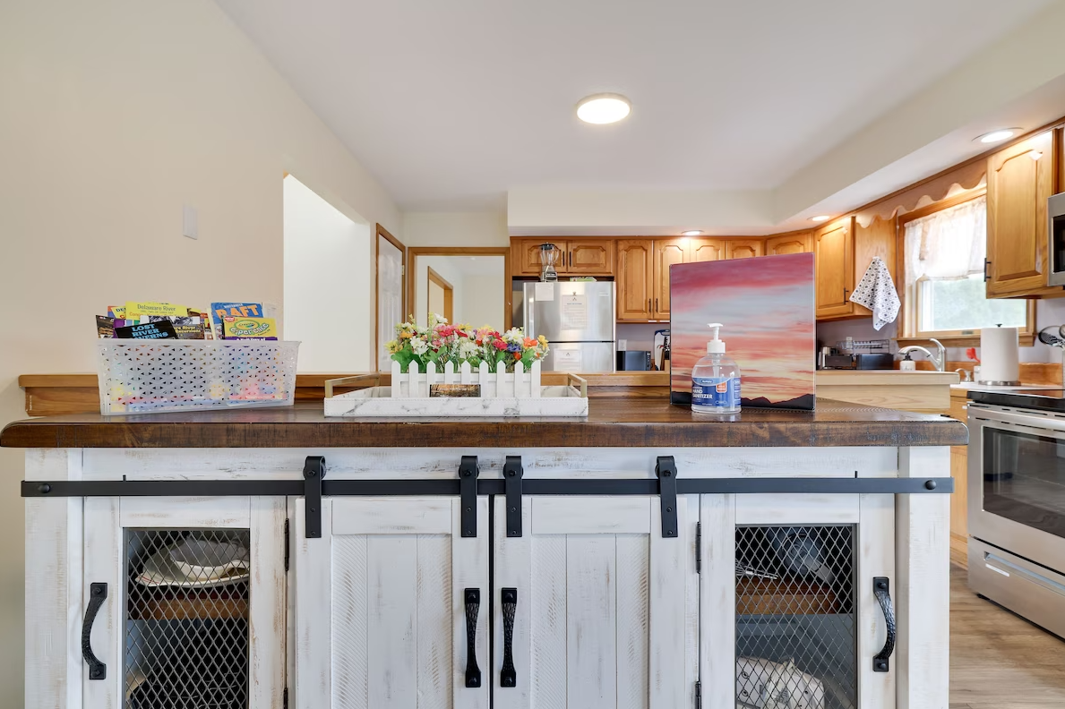 A kitchen with a large island and sliding barn doors