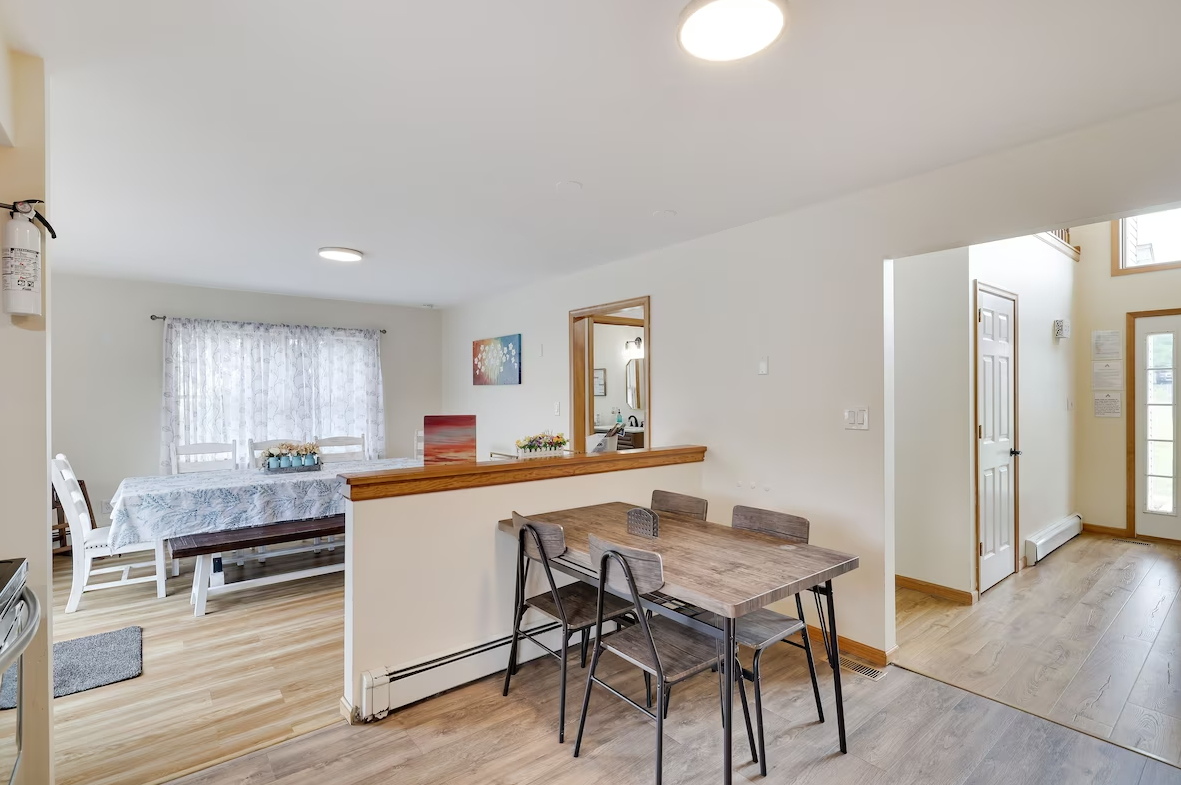 A dining room with a table and chairs in a house.