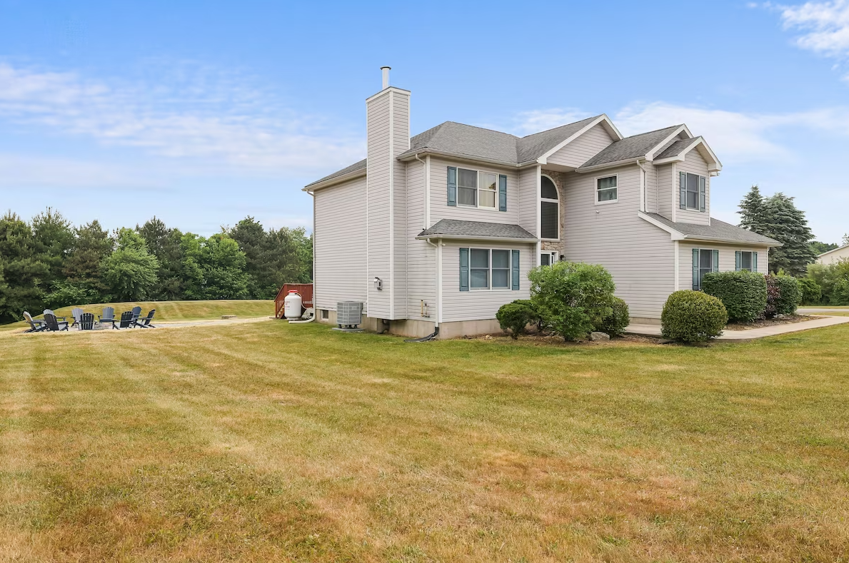 A large house with a large lawn in front of it.