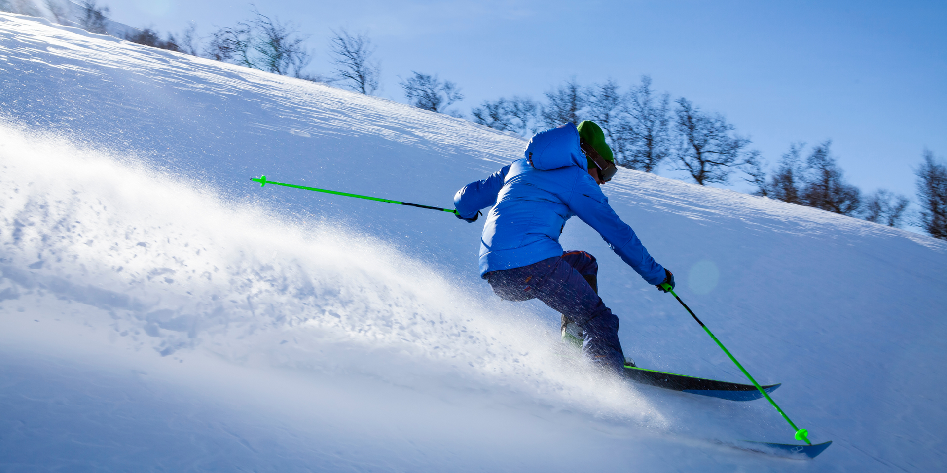 A person is skiing down a snow covered slope.