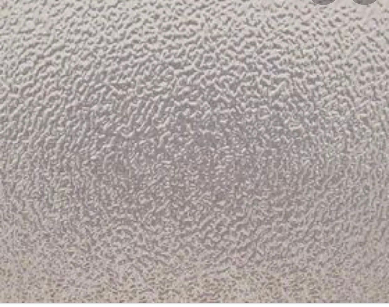 Close-up of a light gray textured wall surface