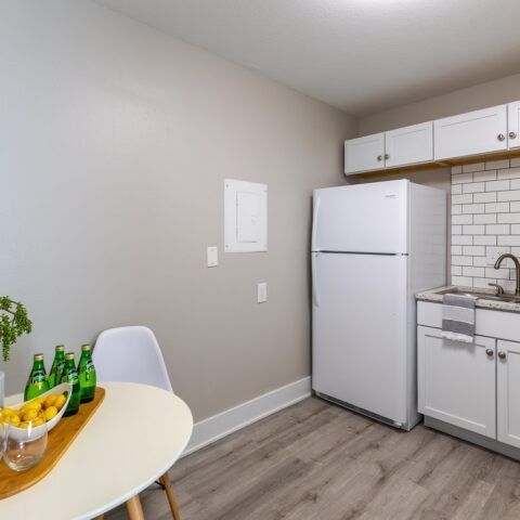 empty kitchen with white cabinets