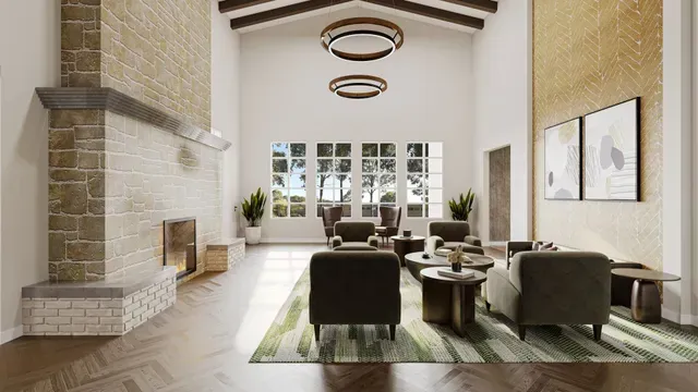 Spacious lounge with fireplace, armchairs, coffee tables, and large windows with outdoor view.