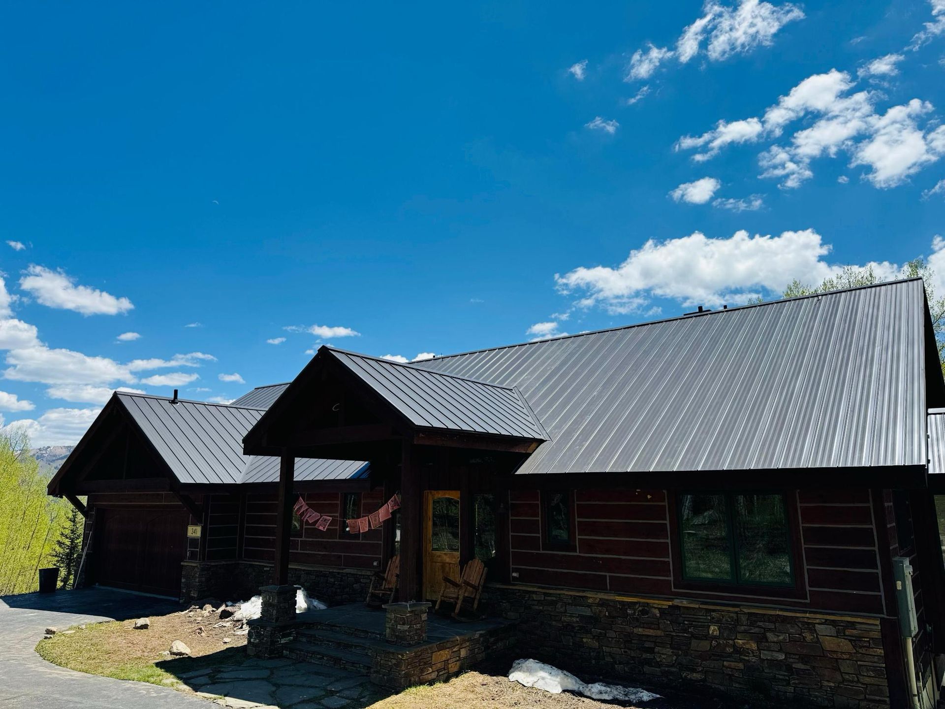 A large log cabin with a metal roof